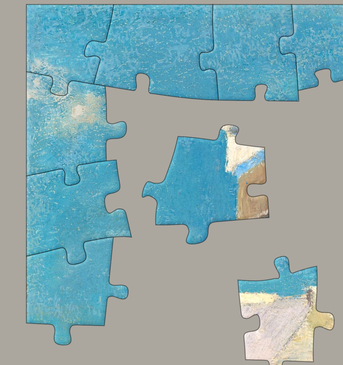 A puzzle part way through: a joined block of sky, with loose pieces lying around it.